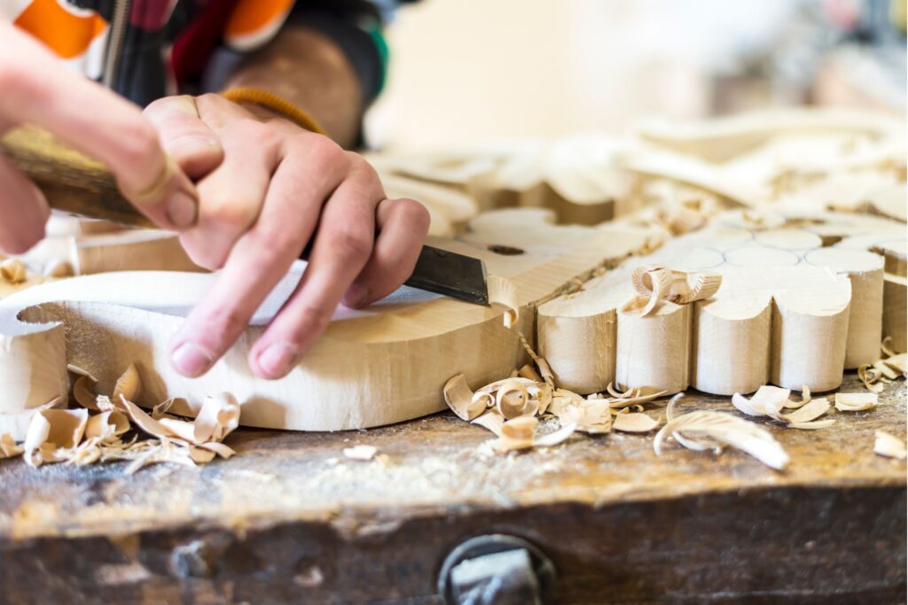 Christmas Market artisans demonstrate traditional craftsmanship creating handmade holiday decorations 1