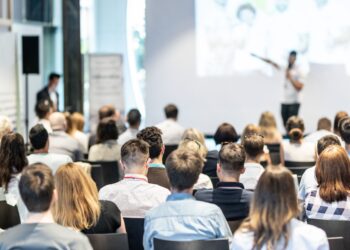Professional networking events in modern European conference center with business attendees