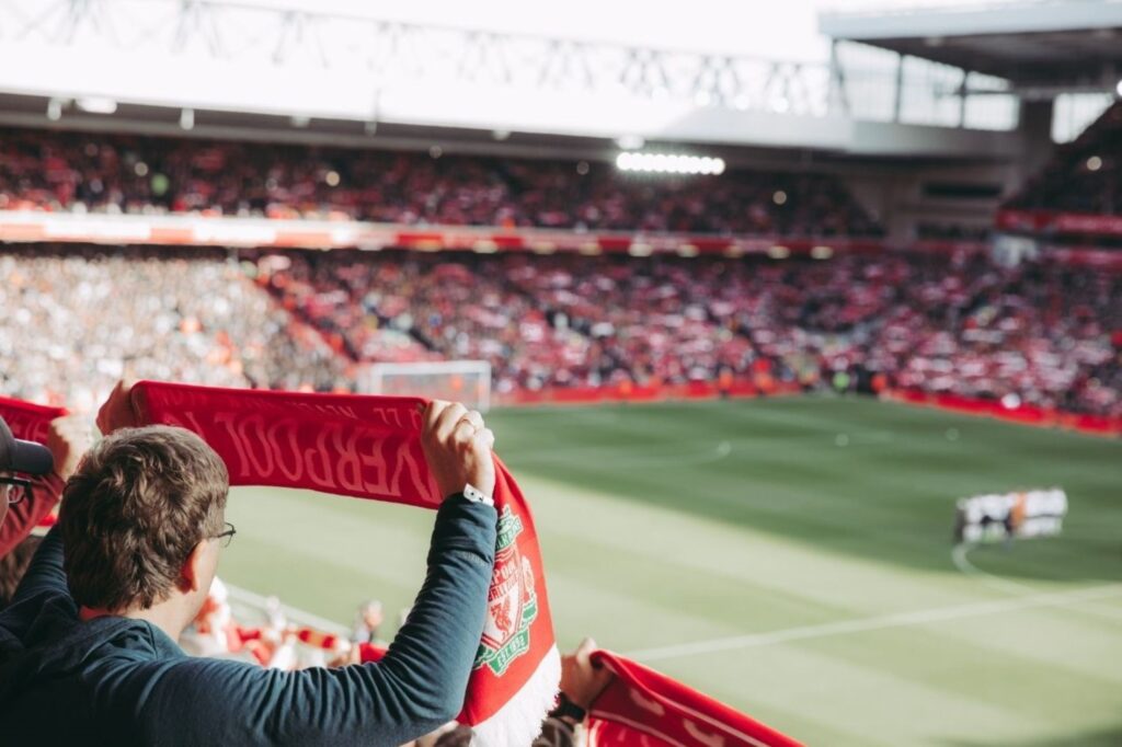 Packed Premier League football stadium during Boxing Day matches on December 26, representing British sporting traditions with local derby fixtures and passionate fan attendance continuing since 19th century