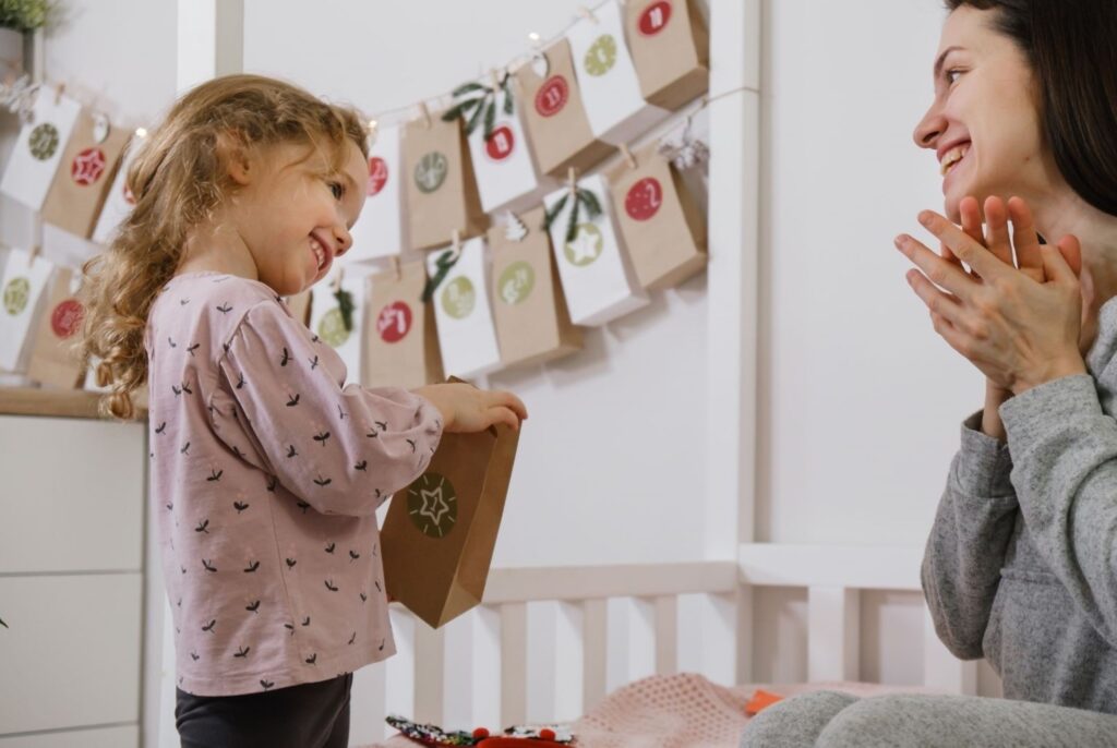 European family enjoying reusable wooden advent calendar with personalized surprises, showcasing modern DIY Christmas countdown ideas creating sustainable meaningful holiday traditions together