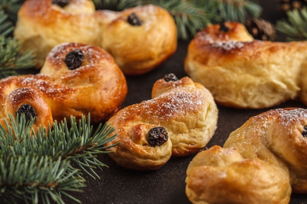 Traditional lussekatter saffron buns with raisins served during Lucia Day festival in Scandinavia, showcasing iconic S-shaped Swedish Christmas treats celebrating December 13 traditions