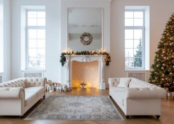 Minimalist Scandinavian Christmas tree decorated with white ornaments, natural wood accents, and warm fairy lights representing Nordic hygge decor style with simple elegant festive touches