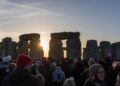 Thousands gathering at Stonehenge for winter solstice sunrise celebrations on December 21, representing ancient European feast traditions honoring shortest day and longest night of year