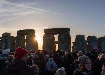 Thousands gathering at Stonehenge for winter solstice sunrise celebrations on December 21, representing ancient European feast traditions honoring shortest day and longest night of year