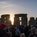 Thousands gathering at Stonehenge for winter solstice sunrise celebrations on December 21, representing ancient European feast traditions honoring shortest day and longest night of year