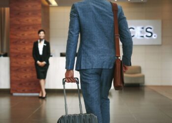 European business travel with professional travelers at airport representing corporate hotel trends
