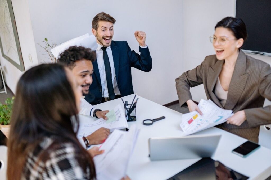 European founders collaborating on bootstrap startup strategy in modern office space