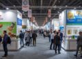 Trade exhibition booths at Anuga showing food industry products and investment opportunities for European market