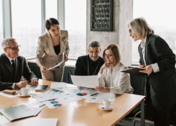 European private equity investment meeting with regional fund professionals analyzing deal flow opportunities