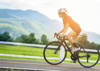 Tour de France 2026 peloton climbing a mountain stage surrounded by thousands of roadside fans