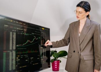 A businesswoman reviews a map of EU cohesion funds allocation by region in a modern office
