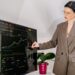 A businesswoman reviews a map of EU cohesion funds allocation by region in a modern office
