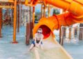 A family enjoying a thrilling water slide at one of Europe's top aqua parks on a sunny summer day