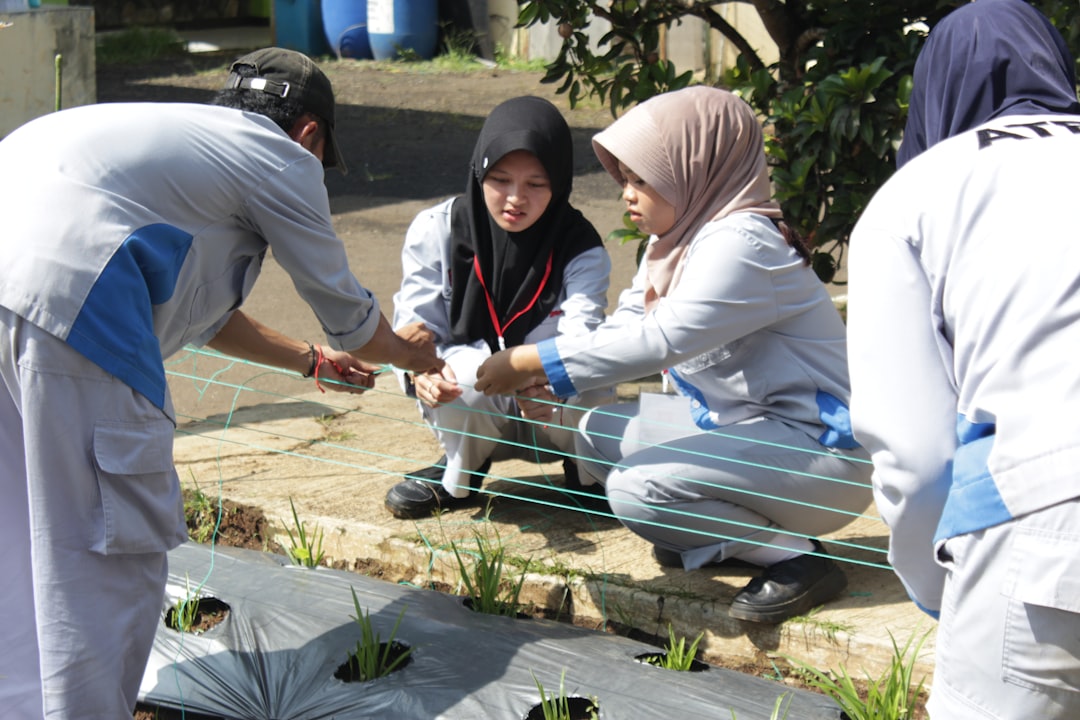 A group of children and a researcher engaging at outdoor science festivals, working together on a STEM activity.