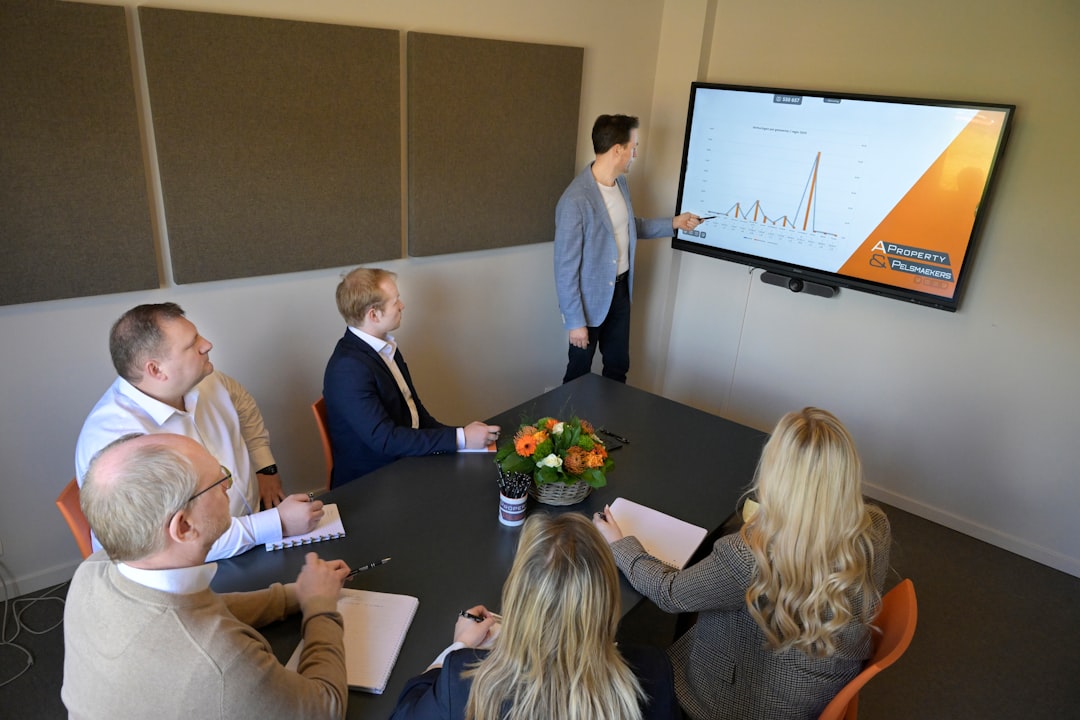 A mixed team discusses a renewable energy project in an office setting and reducing single market barriers.