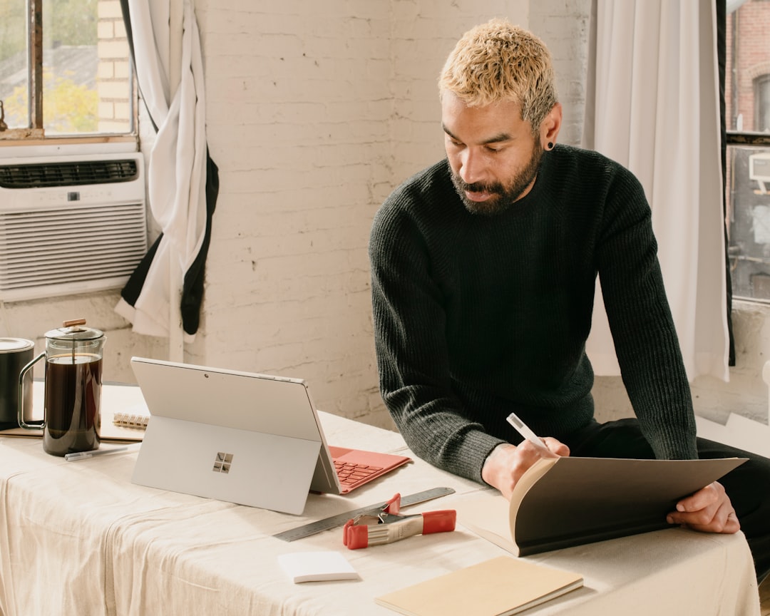 A business owner sits at a desk with documents, illustrating the compliance burden created by single market barriers.