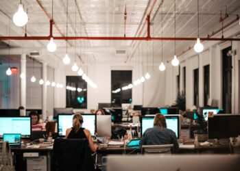 A startup founder researching EU funding programmes on a laptop in a modern office