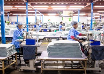 A worker sorting garments at a textile recycling centre, part of the EU's growing circular collection infrastructure