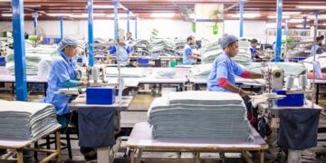 A worker sorting garments at a textile recycling centre, part of the EU's growing circular collection infrastructure