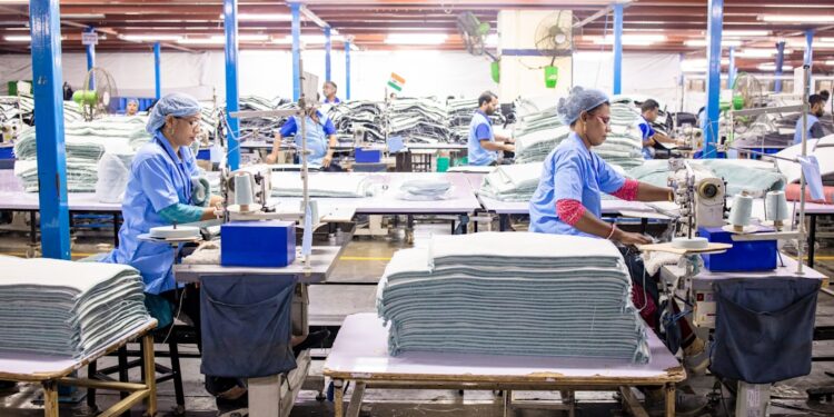 A worker sorting garments at a textile recycling centre, part of the EU's growing circular collection infrastructure