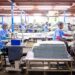 A worker sorting garments at a textile recycling centre, part of the EU's growing circular collection infrastructure