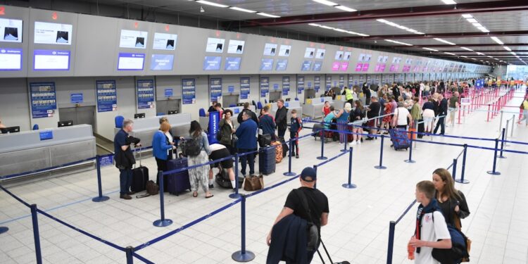 travellers holding passport at an EU airport border, reflecting the changes agreed at the EU–UK summit on eGate access