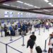 travellers holding passport at an EU airport border, reflecting the changes agreed at the EU–UK summit on eGate access