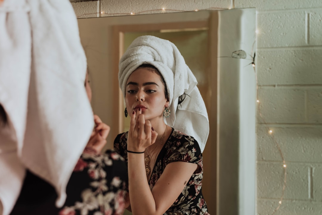 A woman applies a luxurious face cream, her morning routine shaped by the assurance of EU cosmetic standards.