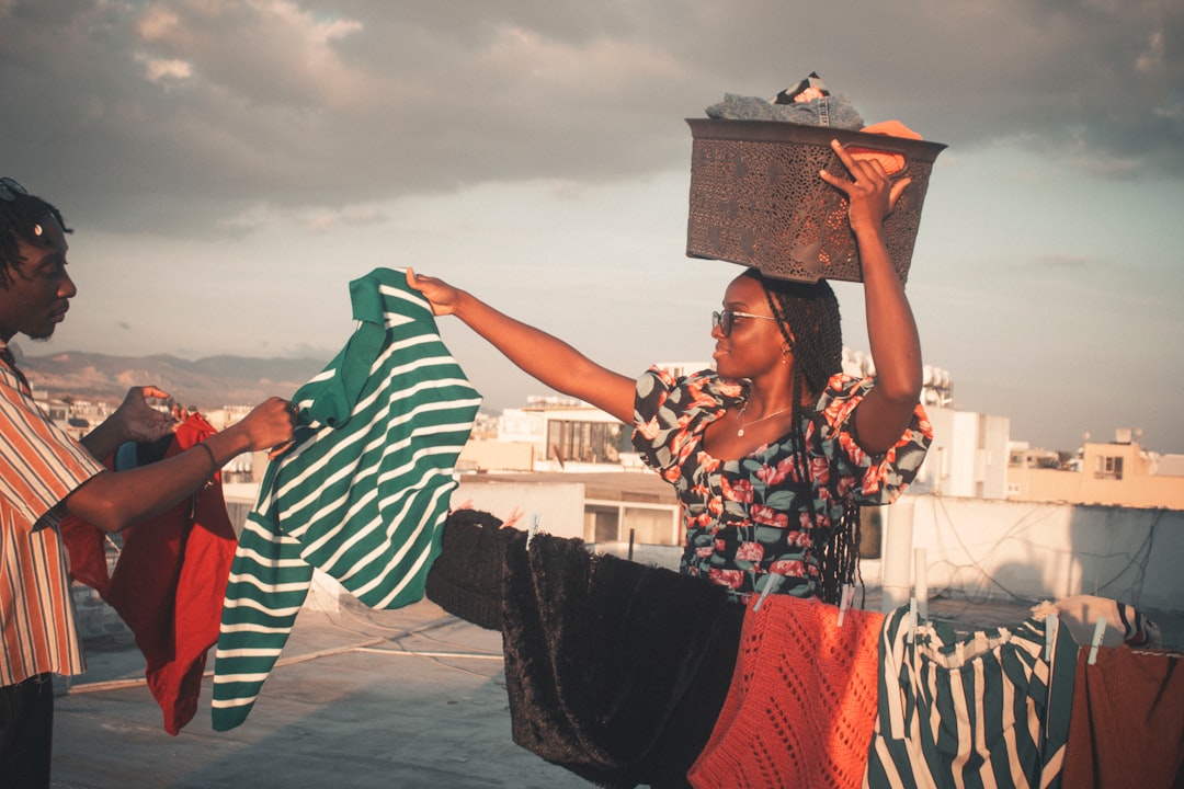 A woman placing used clothing into a separate collection point, supporting EU textile recycling targets