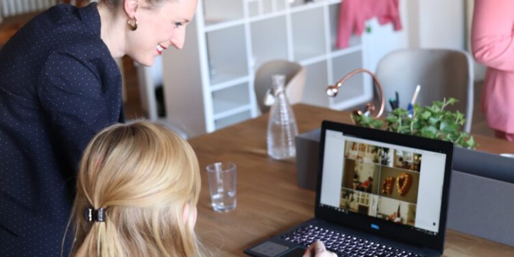 A female founder reviews cross-border e-commerce compliance data on her laptop in a bright European office