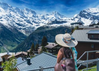 one of the EU's most scenic mountain villages on a clear July morning, surrounded by green peaks.