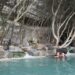 A woman relaxing in a certified thermal spa pool surrounded by historic stone architecture in Europe