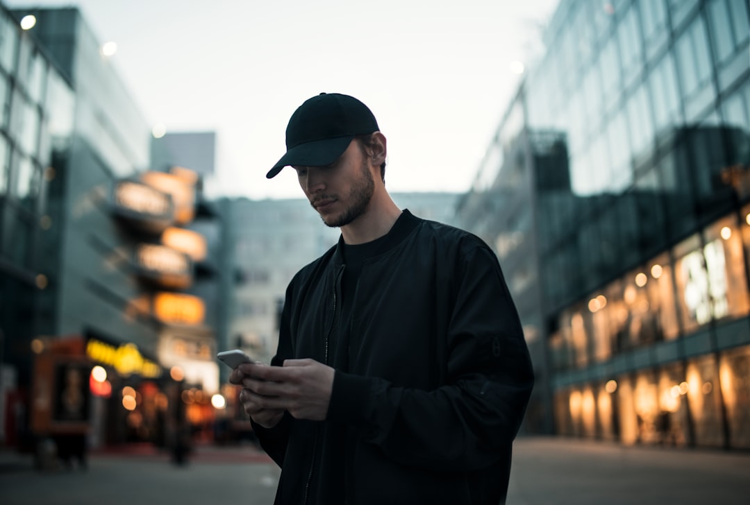 A young European investor uses a mobile broker app to research and buy EU green bonds through a UCITS fund.