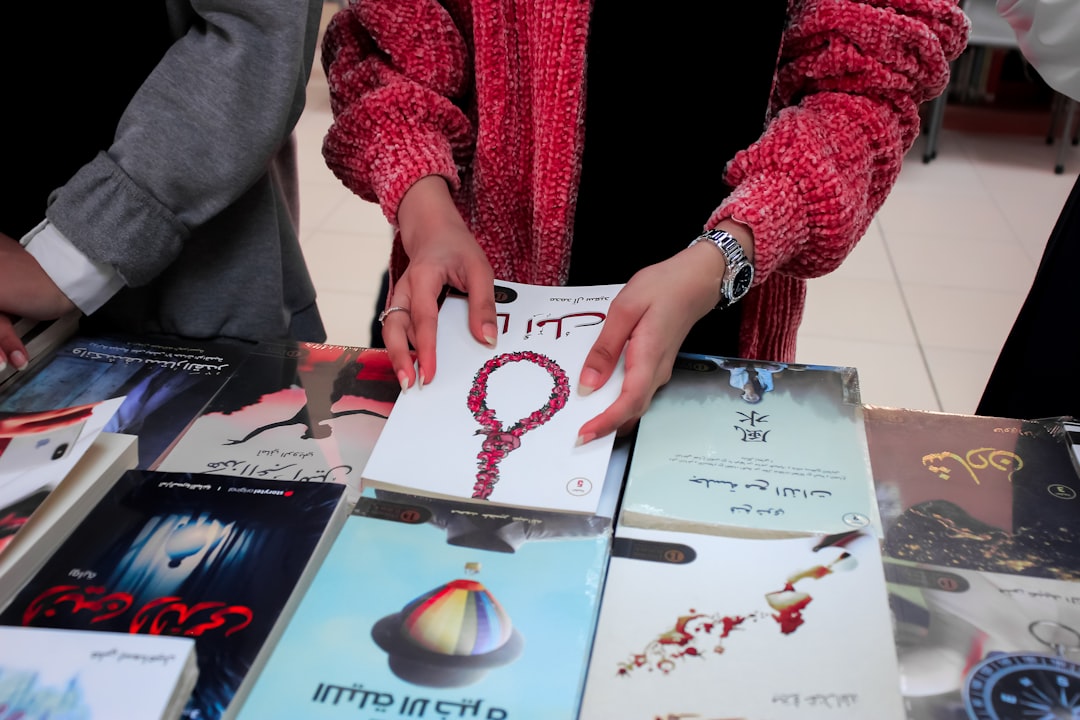 A writer signs copies of a minority language publishing debut at a European literary festival.