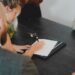 business-people-reviewing-contract-documents-unsplash - EUwebzine Two professionals reviewing a cross-border EU supplier contract at a modern office desk, discussing key clauses.