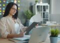 businesswoman-reviewing-supply-chain-documents-unsplash - EUwebzine A sustainability officer reviews supply chain audit documents to prepare for EU Deforestation Regulation compliance.
