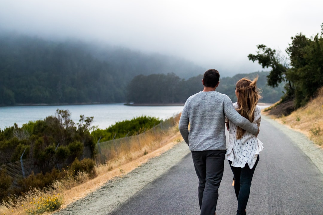 A couple walks through the grounds of an Alpine wellness hotel, reflecting the values of EU-certified wellness retreats.