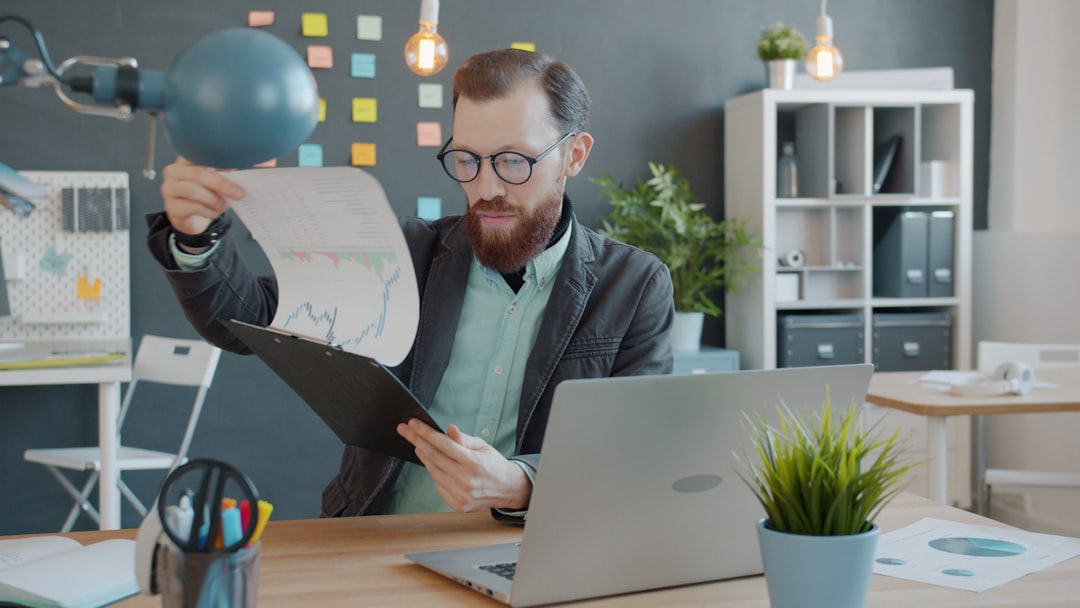 An entrepreneur reviewing a patent application on a laptop, part of a full EU IP protection plan