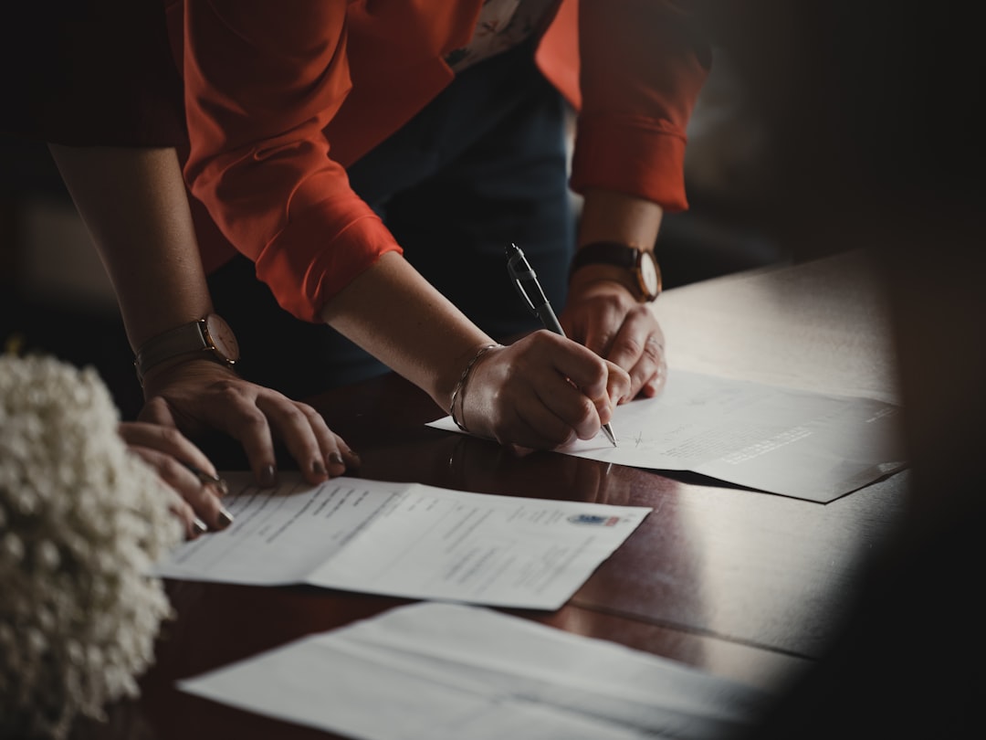 A founder signing a completed EU partnership agreement at a modern European office