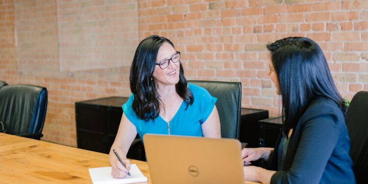 A financial adviser explains ELTIF 2.0 investment options to a retail investor during a one-to-one meeting