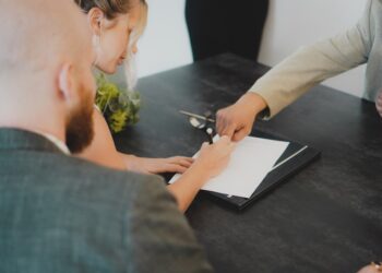 A startup founder signing EU trademark registration documents as part of an IP protection strategy