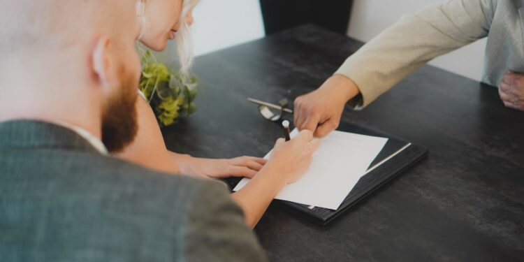 A startup founder signing EU trademark registration documents as part of an IP protection strategy