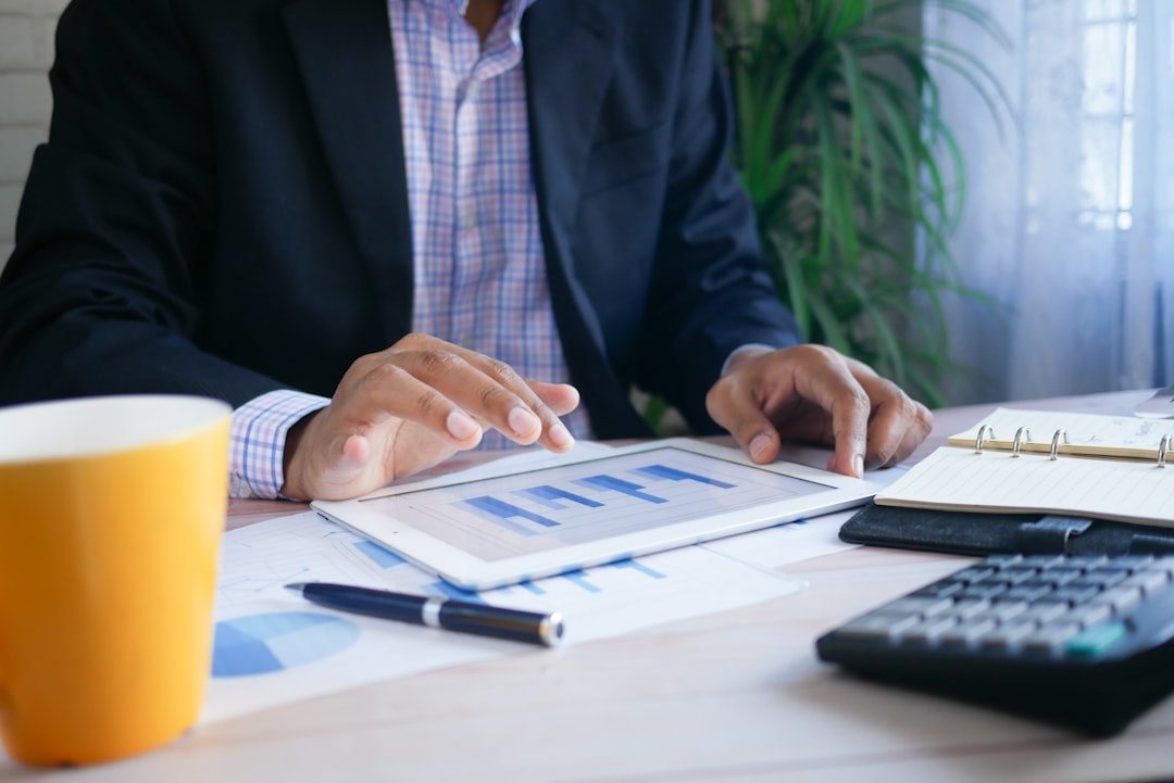 An investor reads an ESG compliance report on a tablet showing supply chain traceability data.