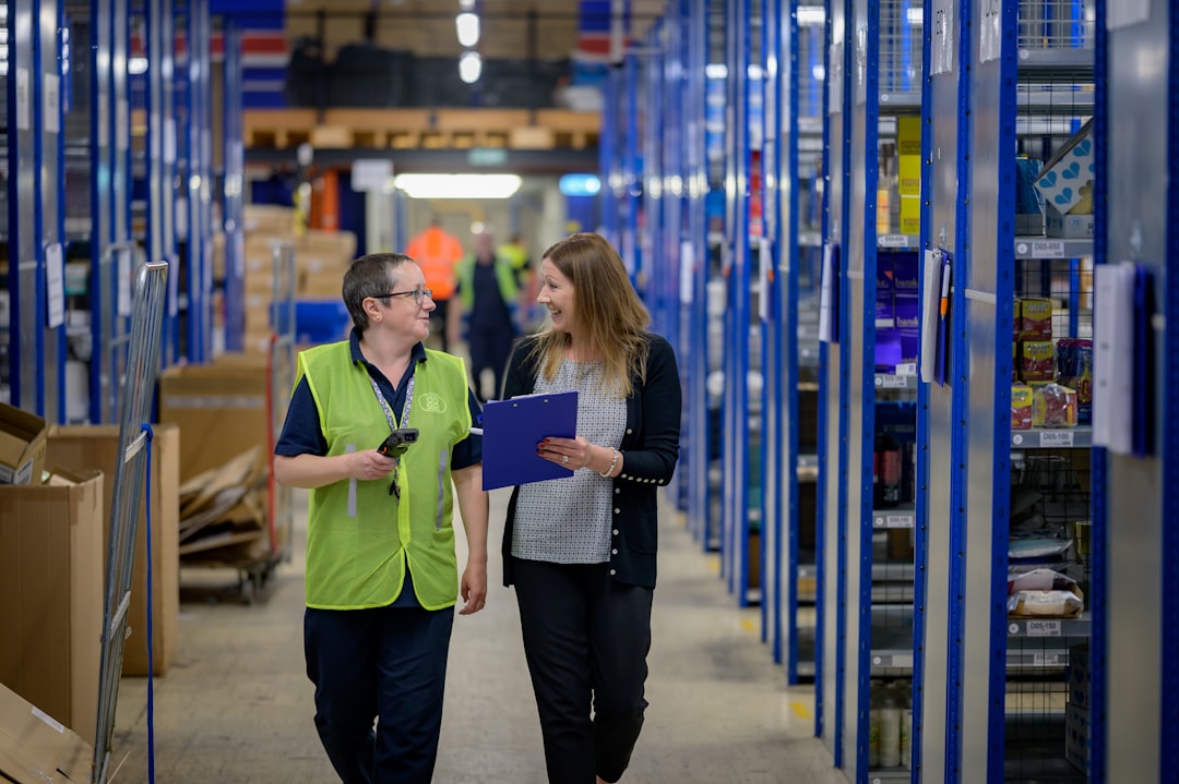 A logistics manager inspects commodities in a warehouse as part of a supply chain audit under EU rules.