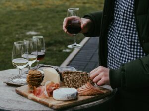 A sommelier carefully pours EU wines beside a regional cheese board at an elegant European table