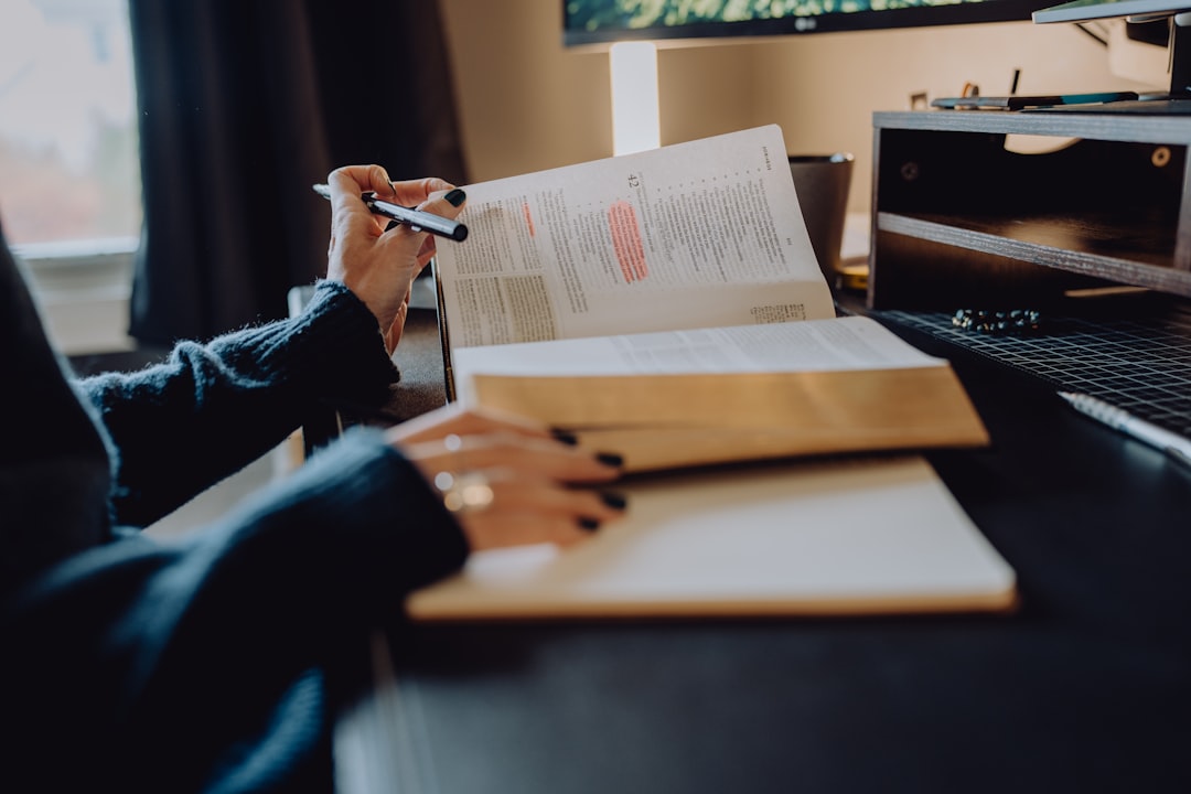 A literary translator works on a manuscript at a desk, supporting the circulation of minority language publishing.