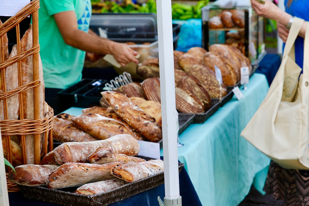 A woman discovers regional wheat-free bread varieties at a harvest season market in Europe