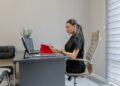 businesswoman-reviewing-contract-documents-unsplash - EUwebzine A procurement manager reviews EU supplier contracts at her desk before Q4 negotiations begin