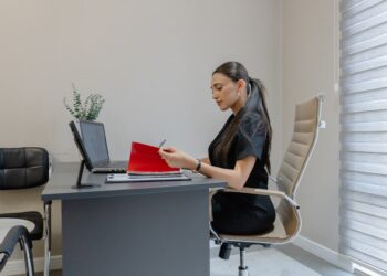 A procurement manager reviews EU supplier contracts at her desk before Q4 negotiations begin