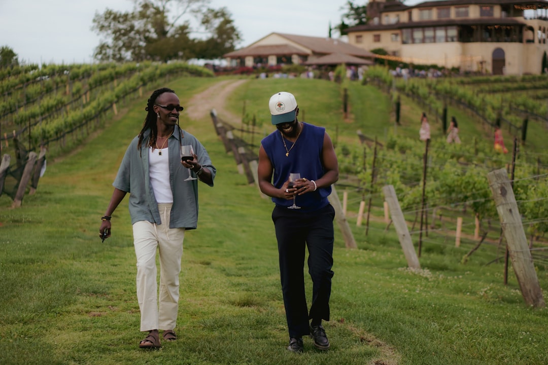 A couple strolling through vine rows during the wine harvest season in a Chianti PDO landscape
